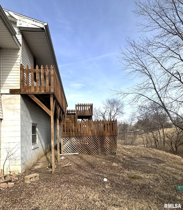 view of property exterior featuring a wooden deck