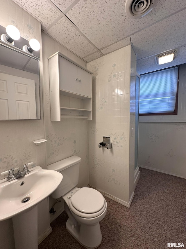 bathroom with a drop ceiling and toilet