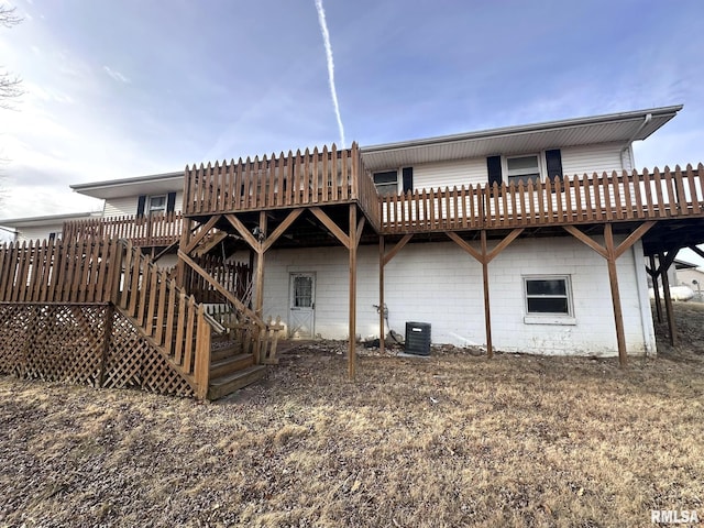 rear view of property with central AC and a deck