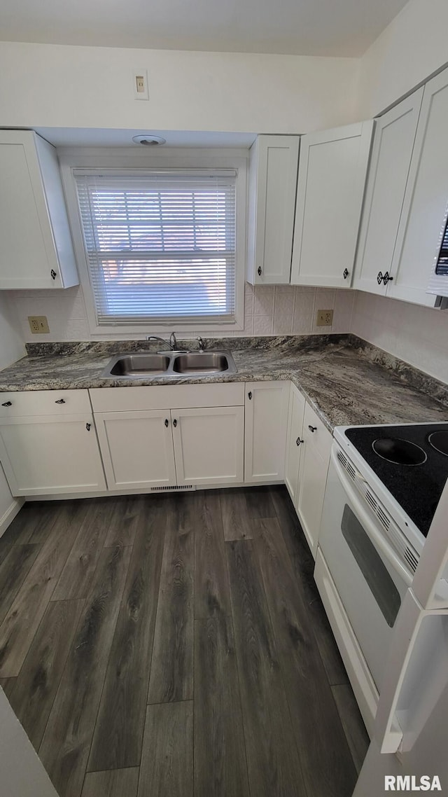 kitchen with dark hardwood / wood-style flooring, sink, electric range, and white cabinets