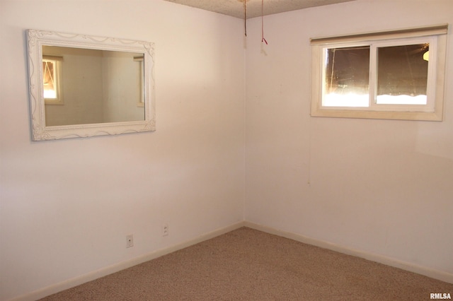 unfurnished room featuring carpet