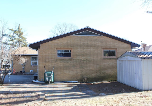 rear view of property with a shed