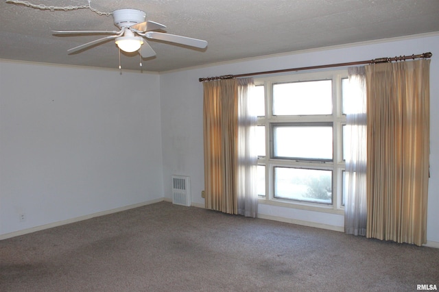 carpeted empty room featuring ornamental molding, a textured ceiling, and ceiling fan