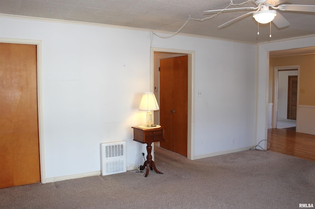 unfurnished room featuring ornamental molding, carpet, a textured ceiling, and ceiling fan