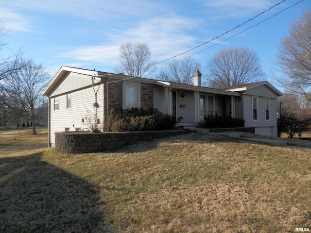 single story home featuring a garage, a front yard, brick siding, and a chimney