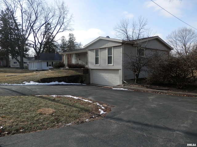 view of front of home with driveway and a garage