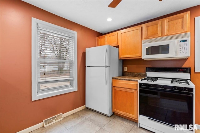 kitchen featuring white appliances, ceiling fan, and light tile patterned flooring