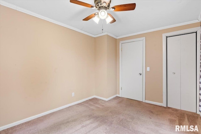 unfurnished bedroom with crown molding, carpet, and ceiling fan