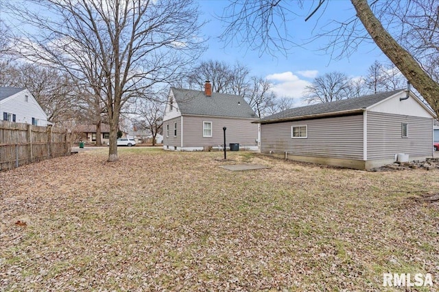 rear view of property featuring a yard