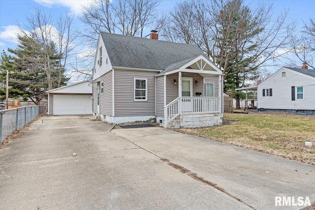 view of front of home with an outbuilding, a garage, and a front lawn