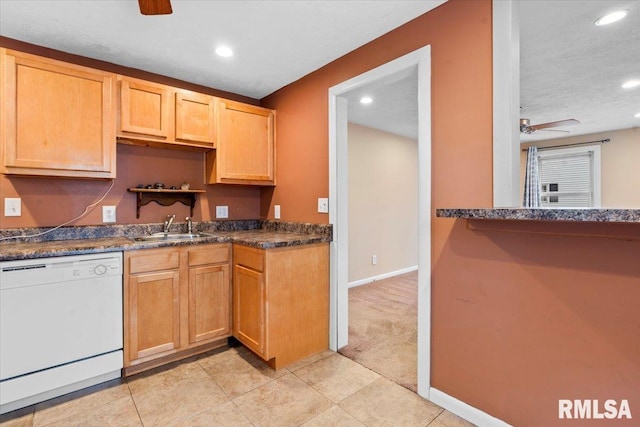 kitchen featuring ceiling fan, dishwasher, sink, and light tile patterned floors