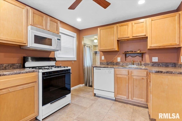 kitchen with sink, light tile patterned floors, ceiling fan, light brown cabinets, and white appliances