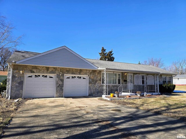 single story home featuring a garage and a porch