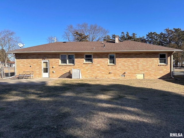 rear view of property with a yard and a patio