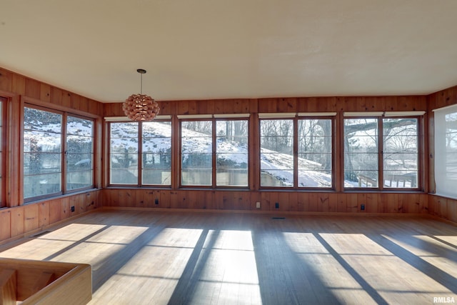 unfurnished sunroom featuring a notable chandelier