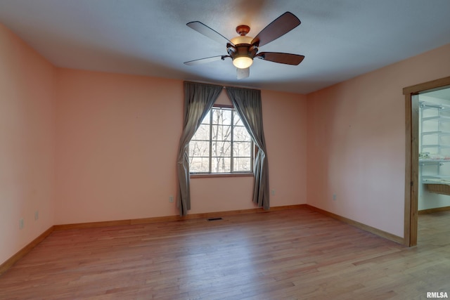 unfurnished room featuring ceiling fan and light hardwood / wood-style flooring