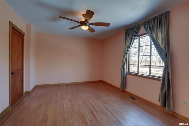 empty room with ceiling fan and light wood-type flooring