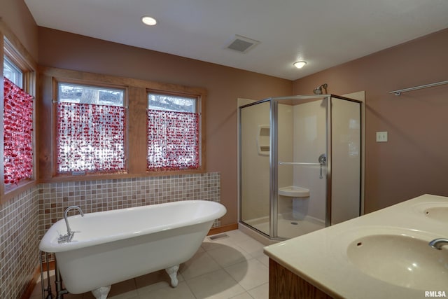 bathroom featuring vanity, tile patterned floors, and plus walk in shower