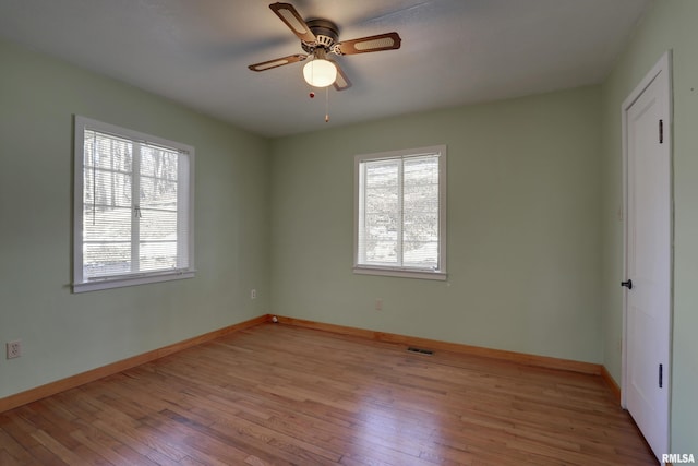 empty room featuring ceiling fan and light hardwood / wood-style floors