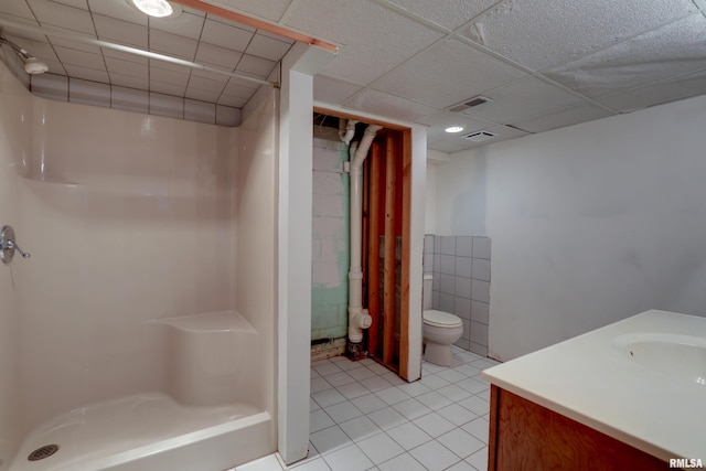 bathroom with walk in shower, vanity, toilet, and tile patterned flooring