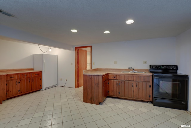 kitchen with white refrigerator, black range with electric stovetop, and sink