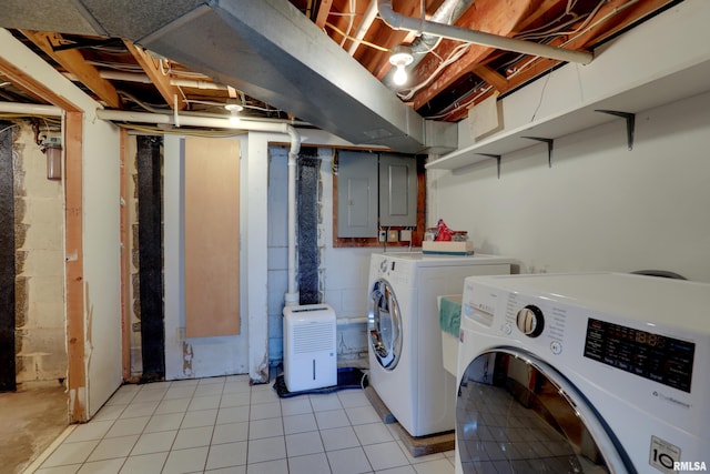 clothes washing area with light tile patterned flooring, electric panel, and independent washer and dryer