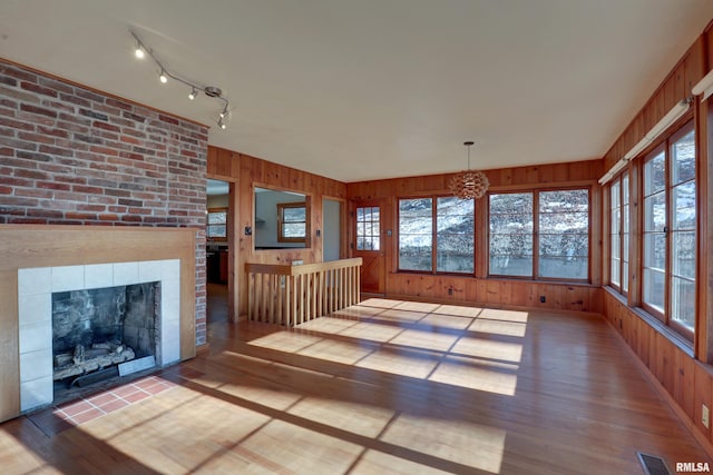 interior space with track lighting and a tile fireplace