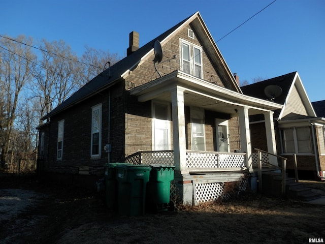 view of side of home with covered porch