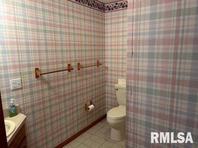 bathroom with tile patterned floors, vanity, and toilet