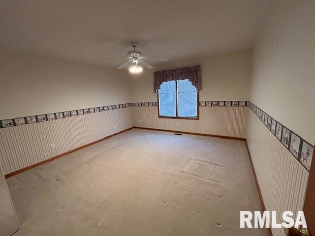 carpeted empty room featuring ceiling fan