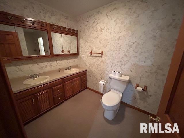 bathroom featuring vanity and toilet