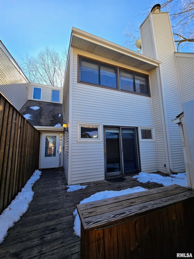 snow covered property featuring a deck