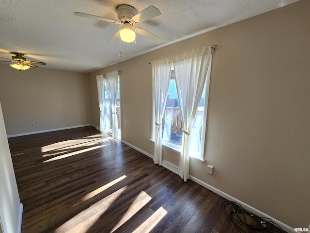 empty room featuring dark hardwood / wood-style floors and ceiling fan