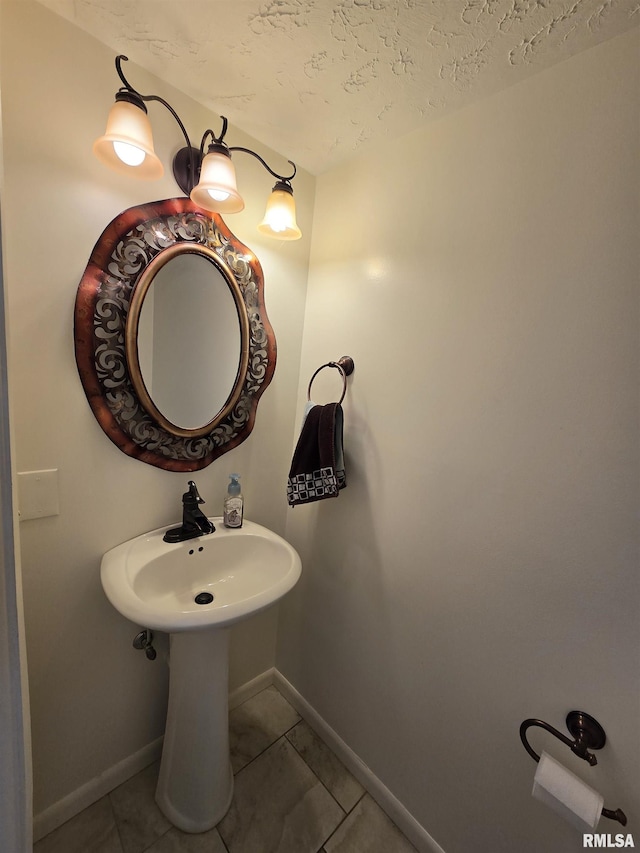 bathroom featuring tile patterned flooring and a textured ceiling