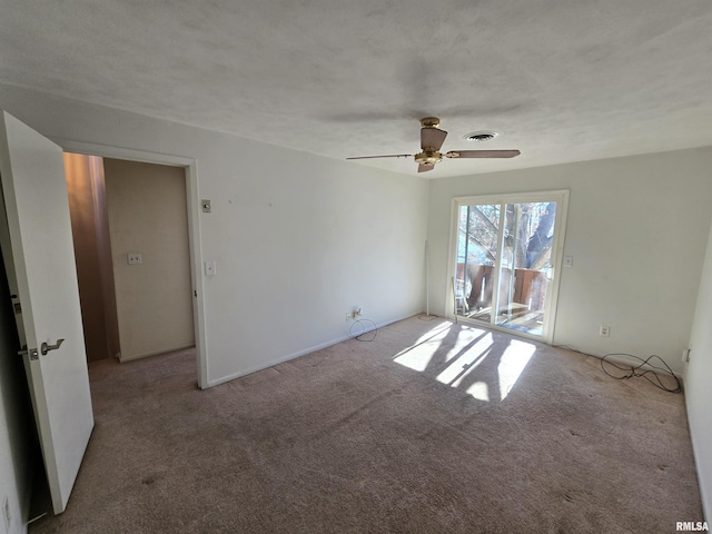 carpeted empty room featuring ceiling fan and a textured ceiling