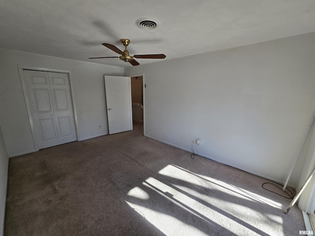 unfurnished bedroom with a closet, ceiling fan, and carpet