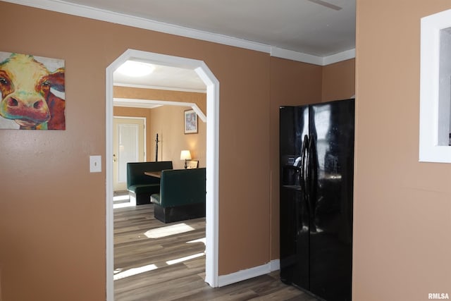 hallway with hardwood / wood-style flooring and ornamental molding