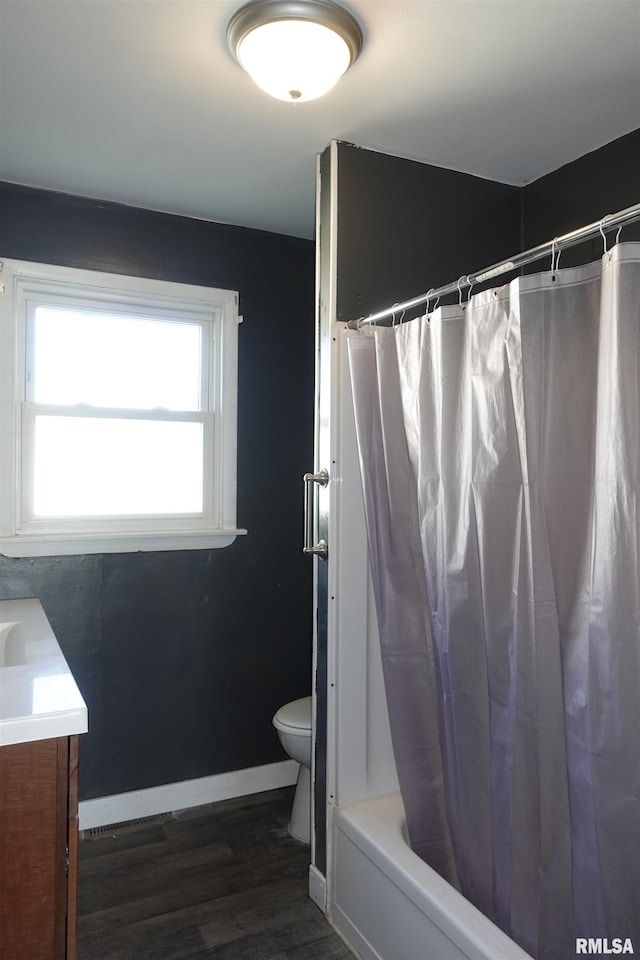 full bathroom with toilet, wood-type flooring, shower / bathtub combination with curtain, and vanity