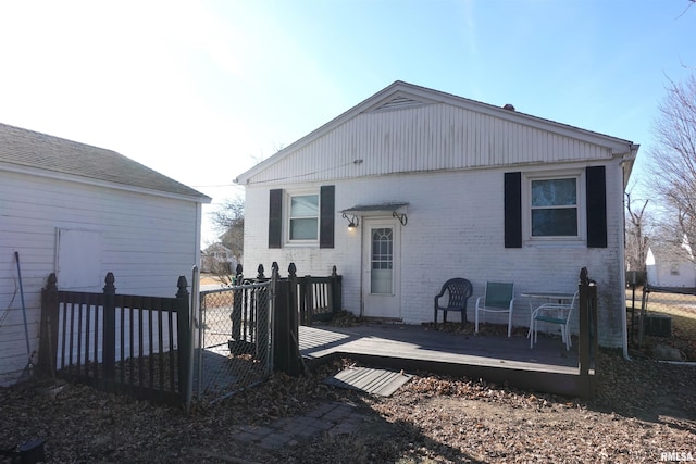 back of house with a deck