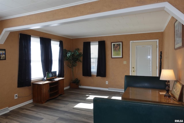 unfurnished living room with hardwood / wood-style flooring and crown molding