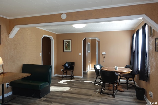 dining room with ornamental molding and dark hardwood / wood-style flooring