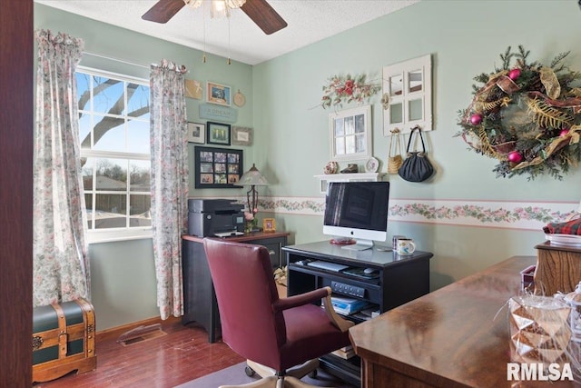 office area with a textured ceiling, wood-type flooring, and ceiling fan