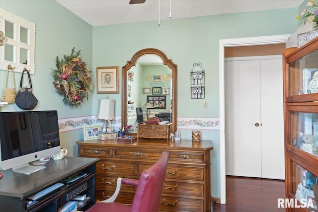 office featuring ceiling fan, a textured ceiling, and dark hardwood / wood-style flooring