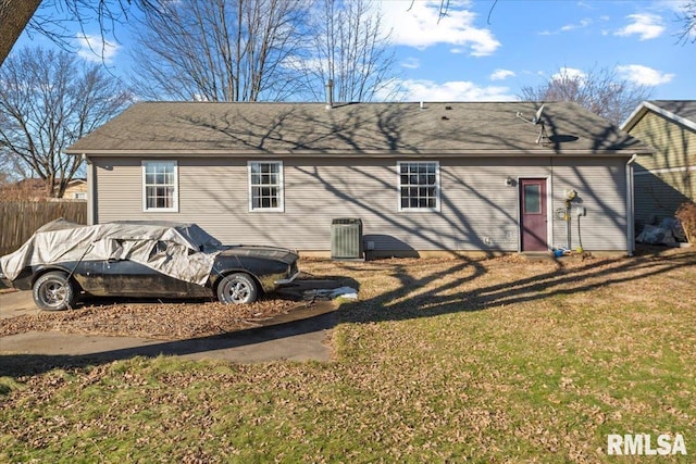 back of house with a lawn