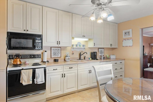 kitchen featuring sink, white cabinets, ceiling fan, and white range with electric cooktop