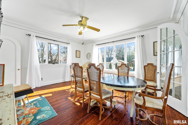 dining area with ornamental molding, dark hardwood / wood-style floors, and ceiling fan