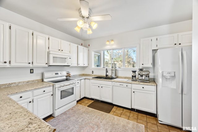 kitchen featuring white cabinetry and white appliances