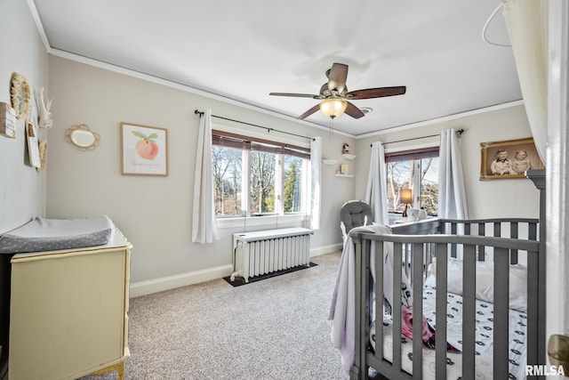 bedroom featuring light carpet, radiator, a crib, and ornamental molding