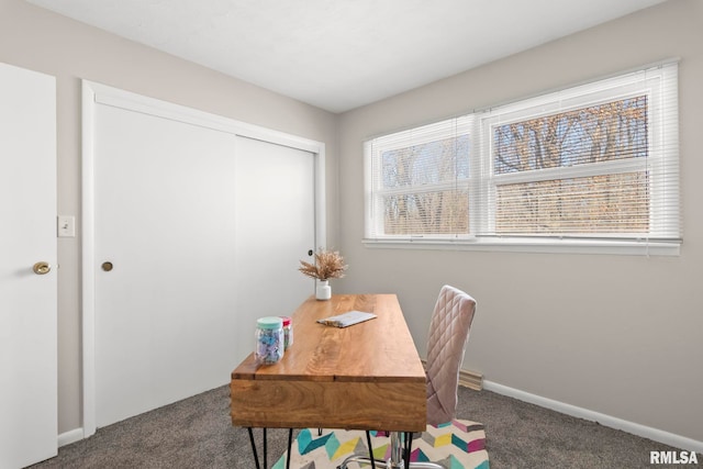 home office featuring a wealth of natural light and dark carpet