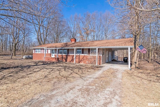 ranch-style house featuring a carport